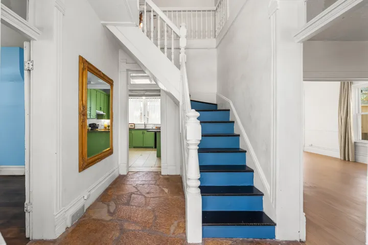 Stairway featuring baseboards and stone finish flooring