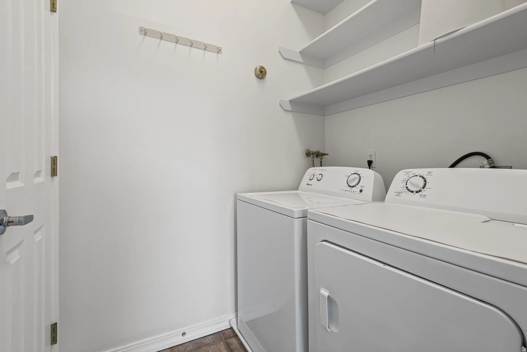 Laundry area with included washer and dryer (utility closet across)