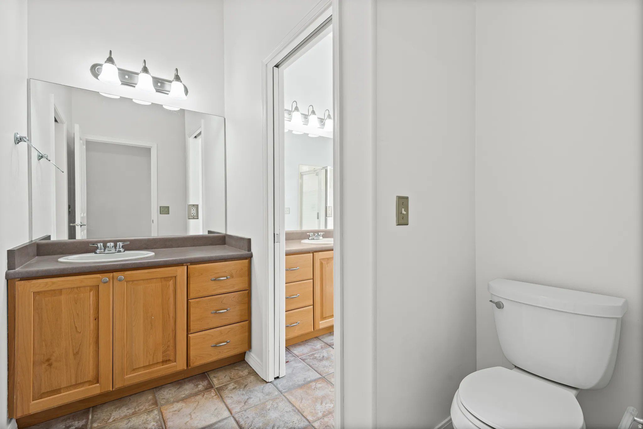 Hollywood bathroom with separate vanities and private ares for guests vs. owner.