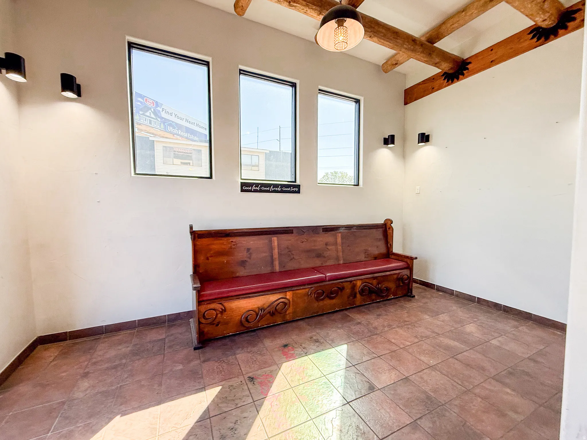 Sitting room featuring beam ceiling and baseboards