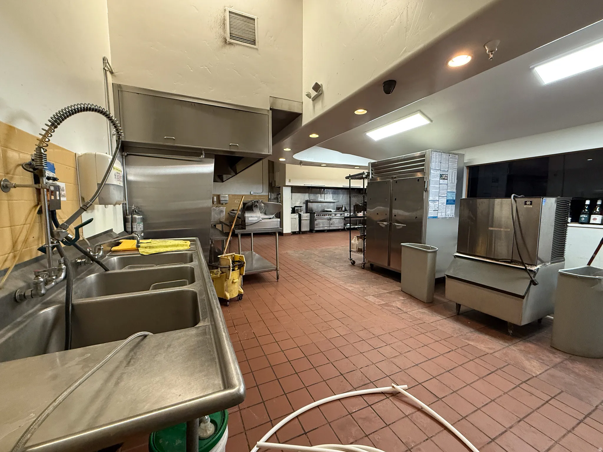 Kitchen with stainless steel refrigerator and recessed lighting