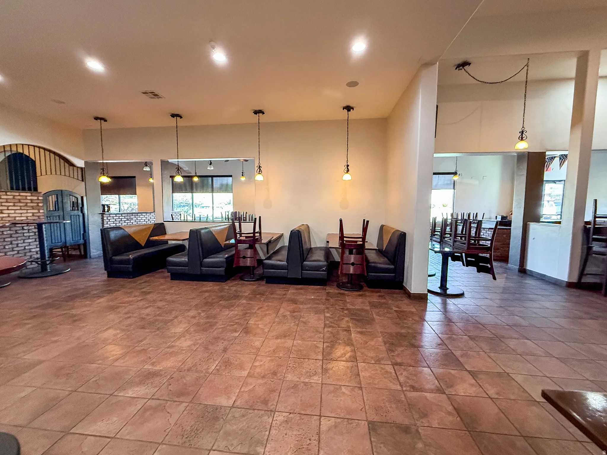 Living area featuring a high ceiling and recessed lighting