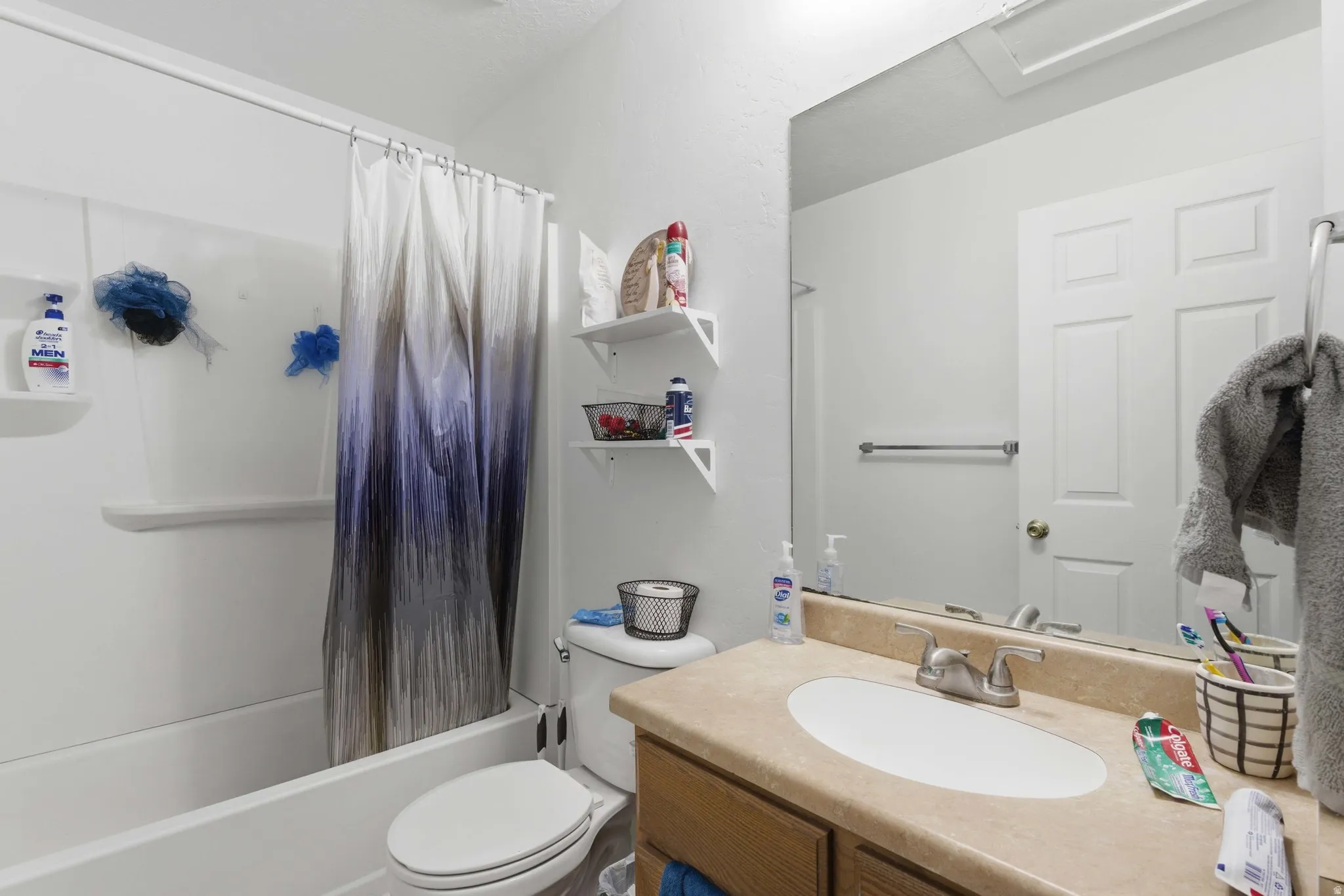 Full bath featuring vanity and shower / bath combo with shower curtain