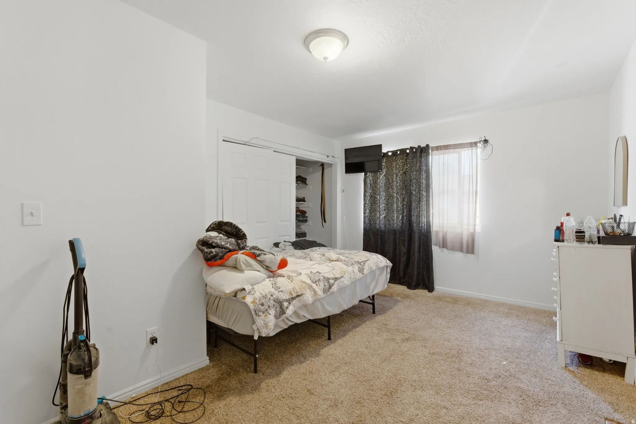 Bedroom featuring a closet and light carpet