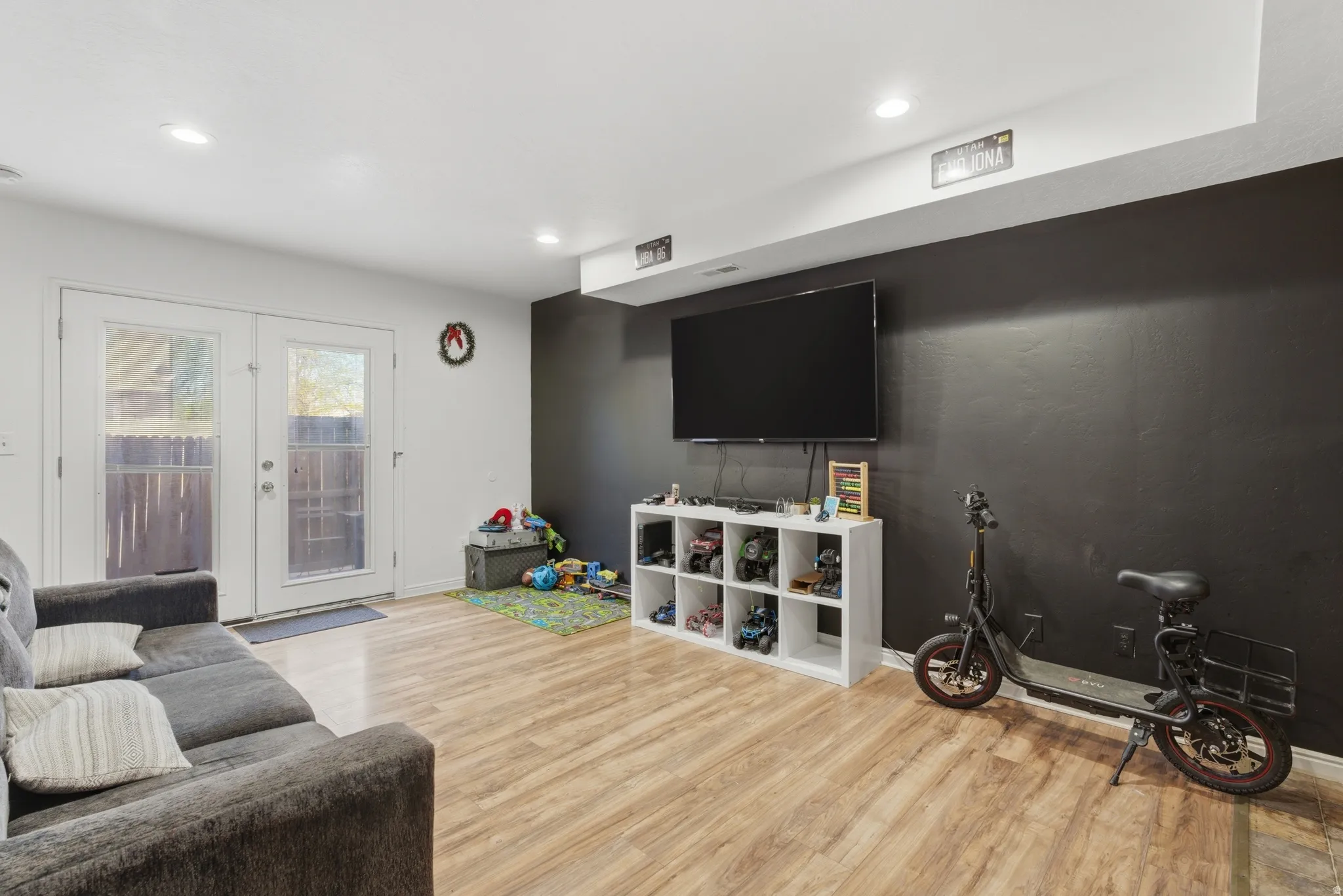 Living room featuring french doors, light wood finished floors, and recessed lighting