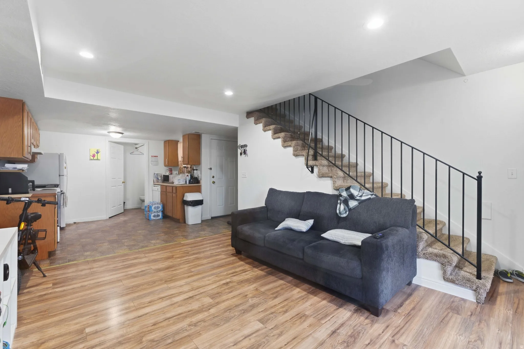 Living room with light wood-type flooring and recessed lighting