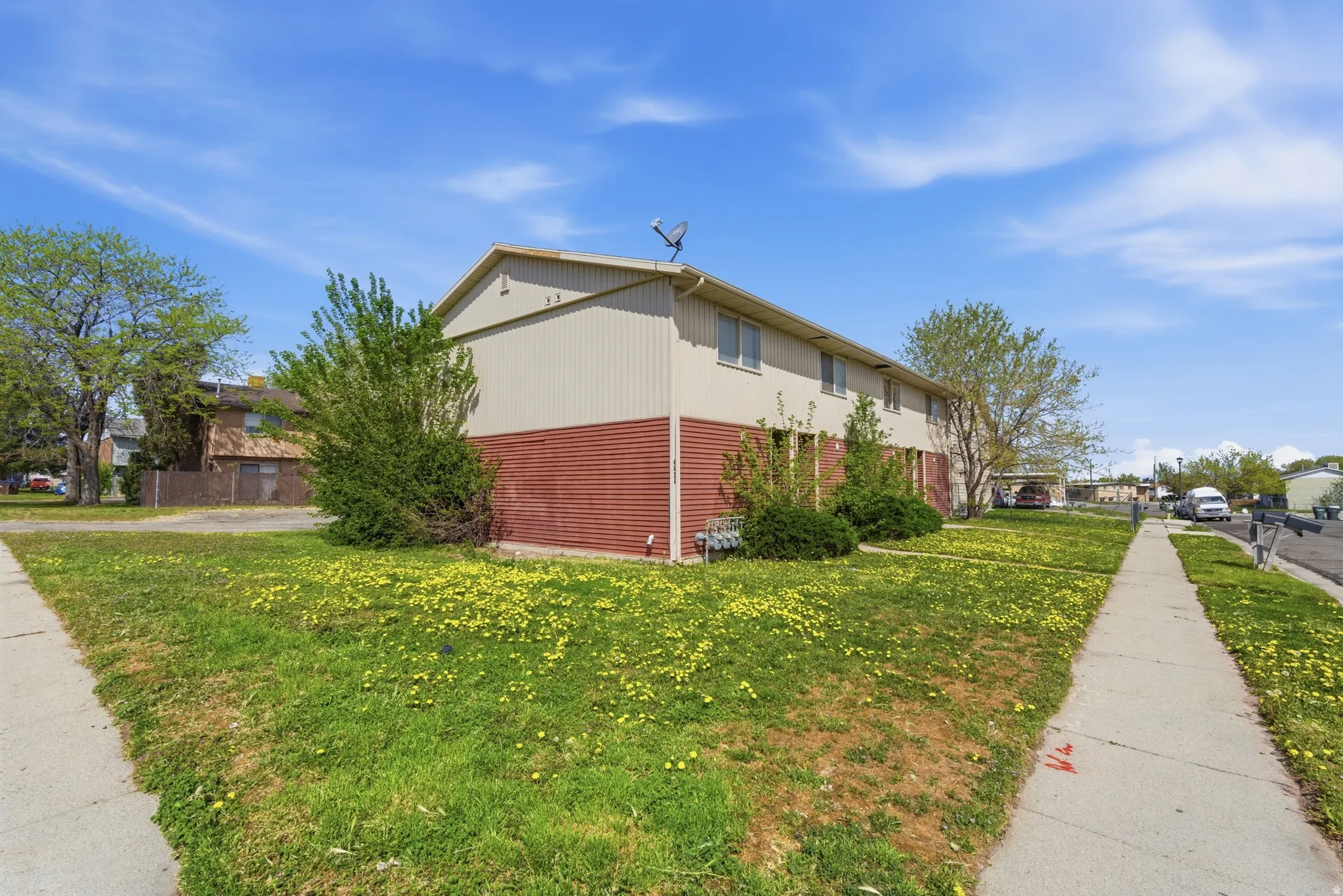 View of property exterior with a yard and a residential view