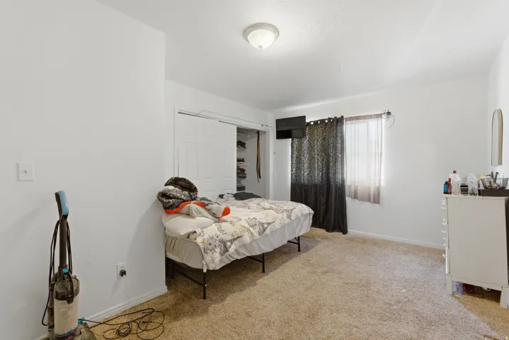 Bedroom featuring a closet and light carpet