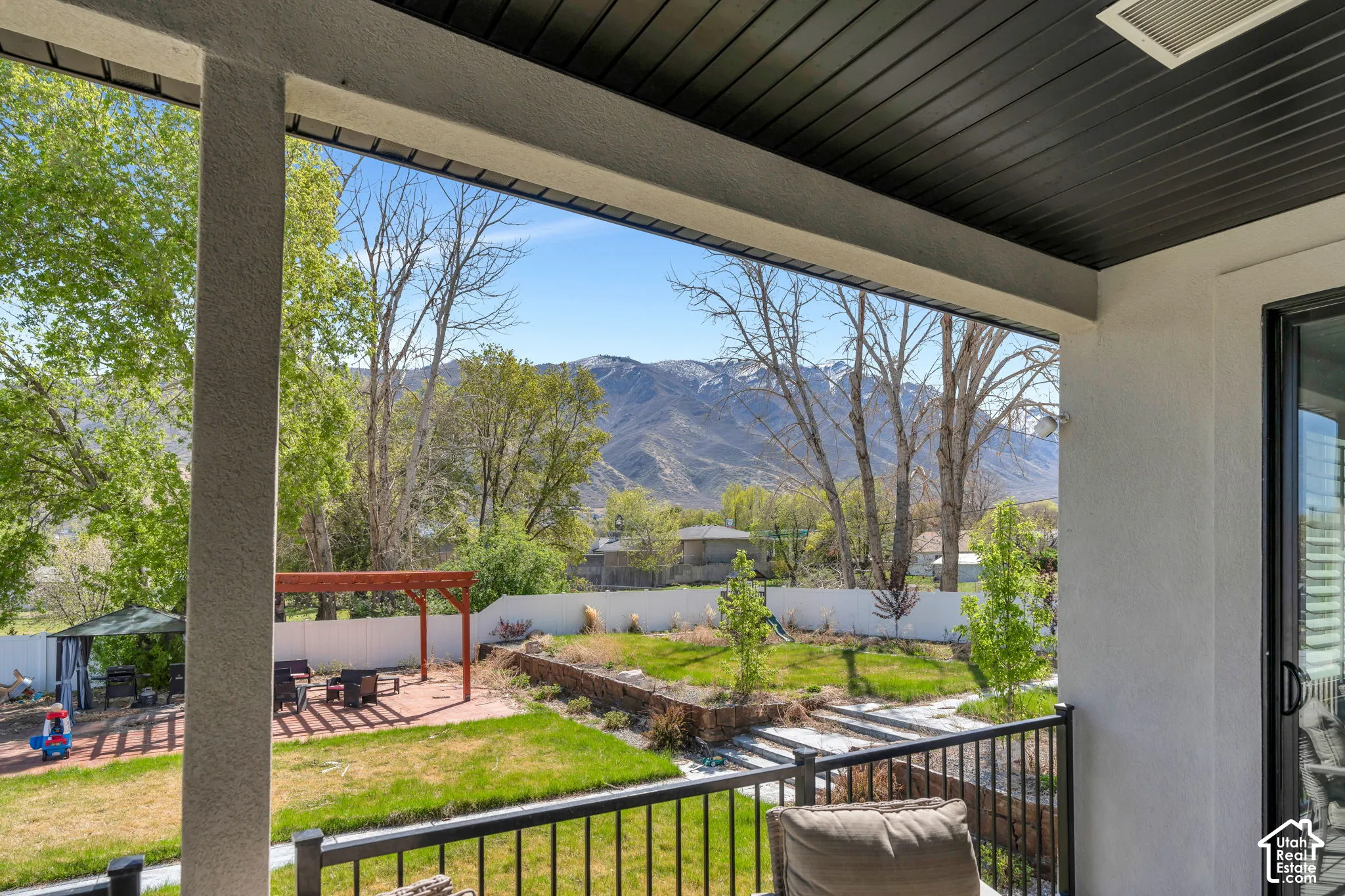 Fenced backyard with a mountain view, a patio, and a pergola