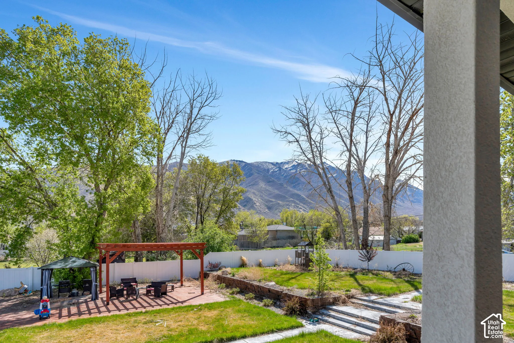 Fenced backyard featuring a patio area, a pergola, a mountain view, and a gazebo