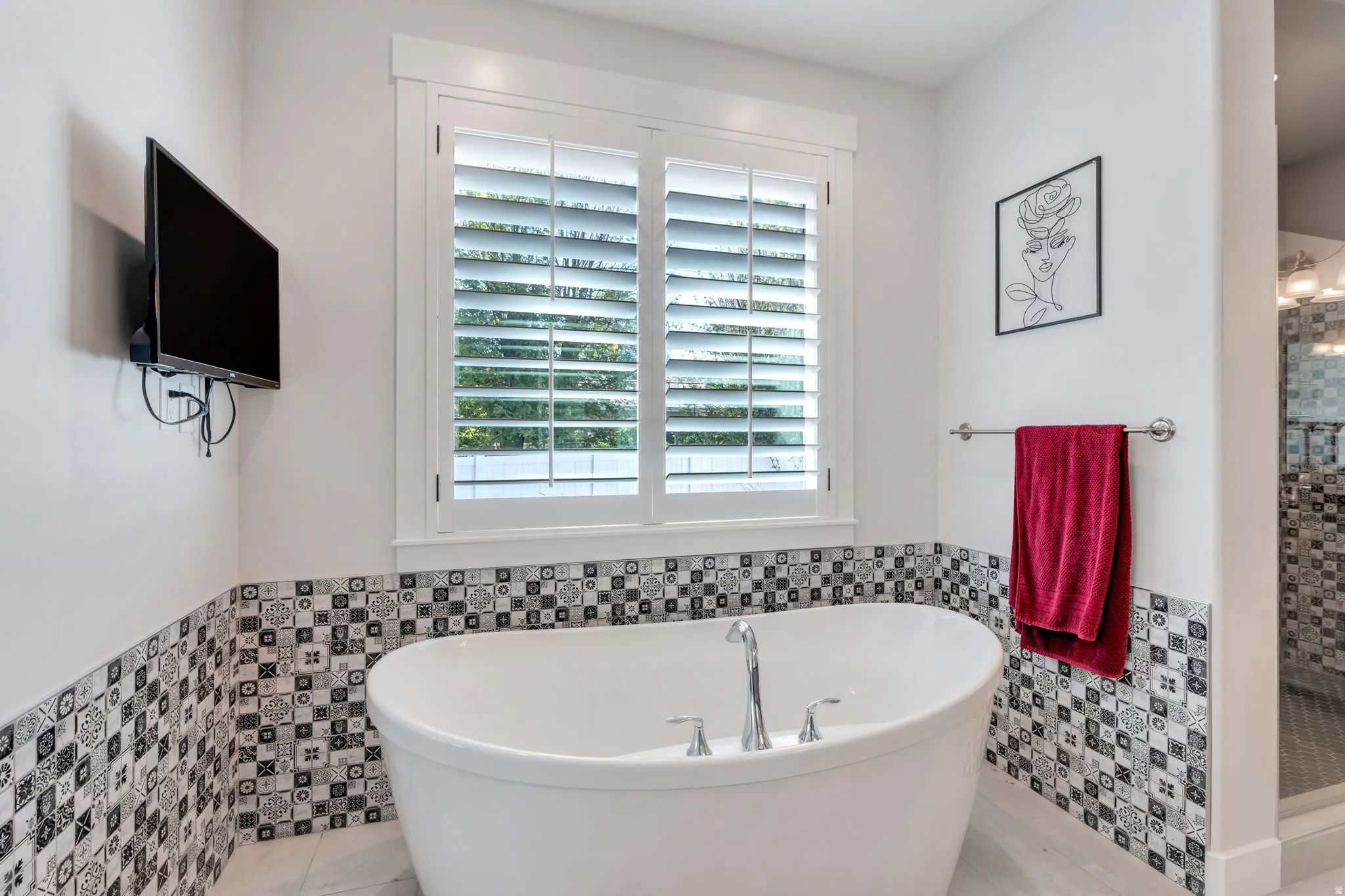 Master bath has standalone soaking tub