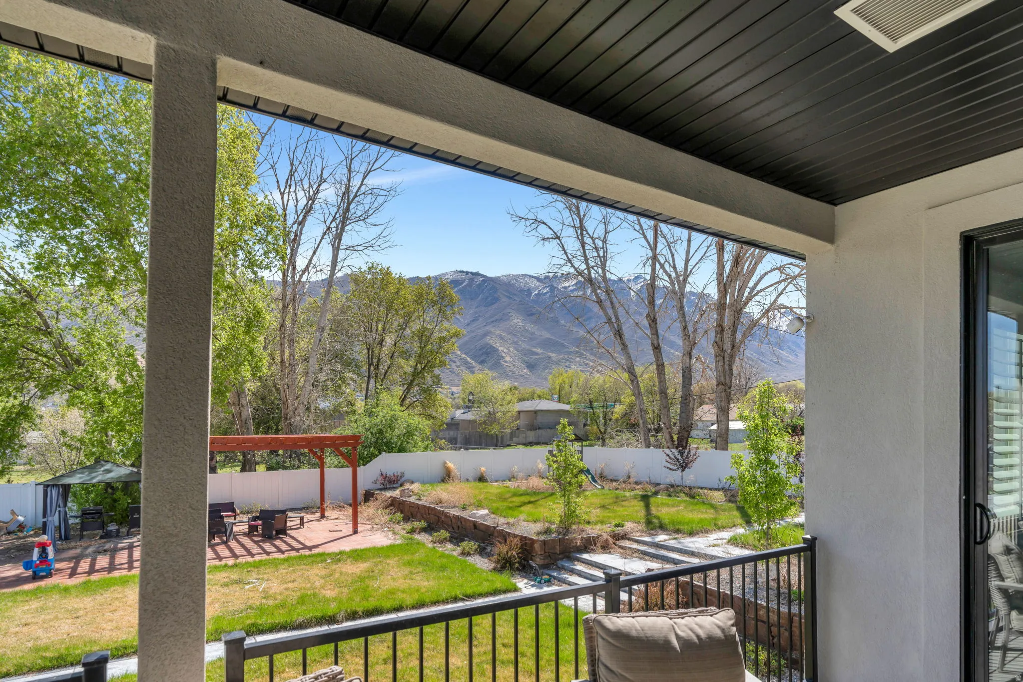 Fenced backyard with a mountain view, a patio, and a pergola