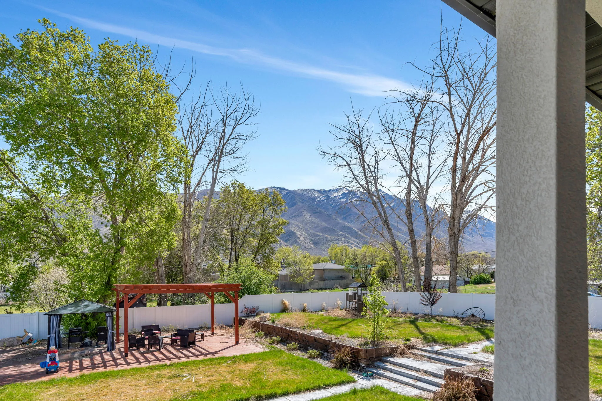 Fenced backyard featuring a patio area, a pergola, a mountain view, and a gazebo