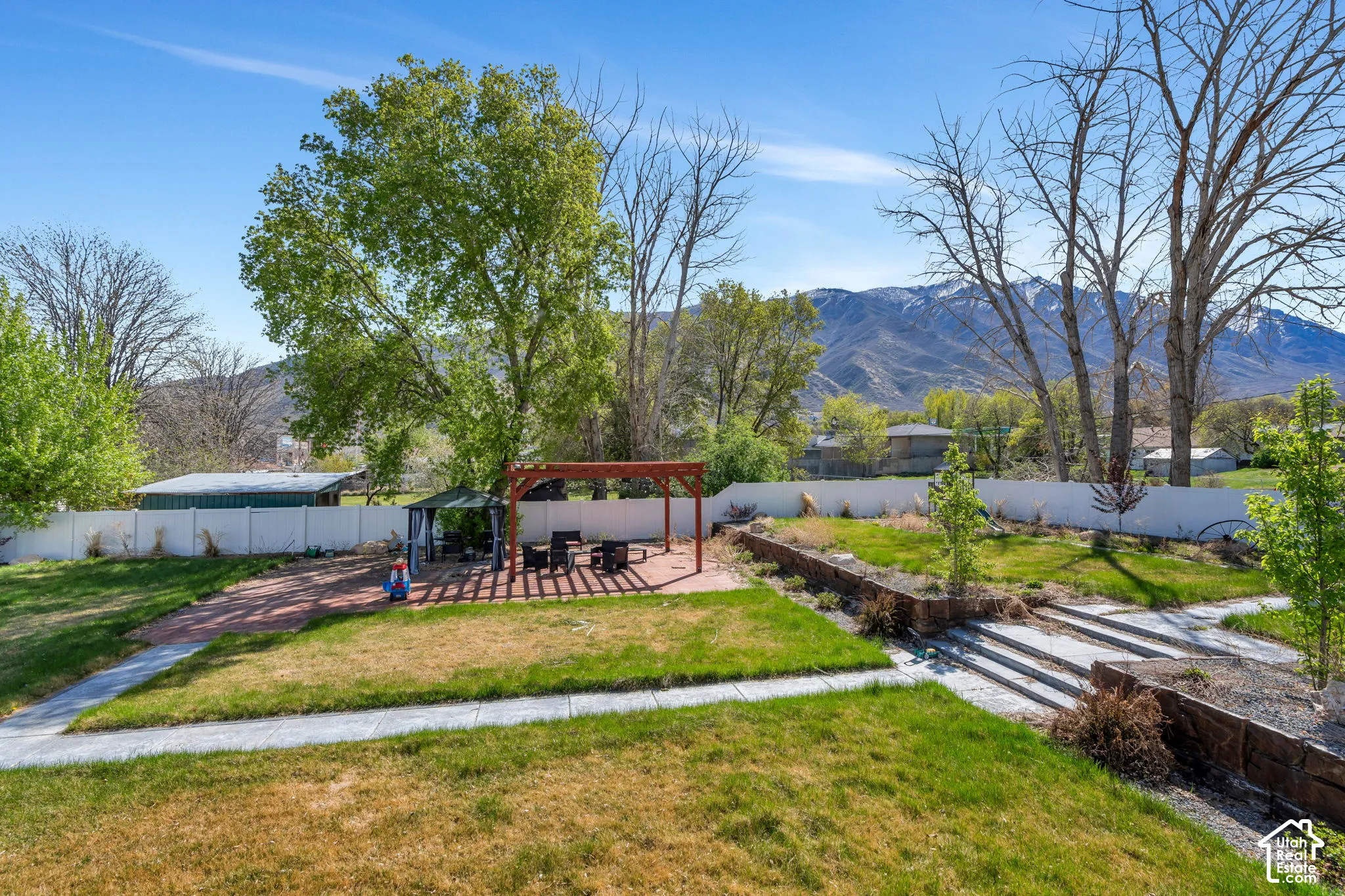 Fenced backyard with a patio, a pergola, and a mountain view