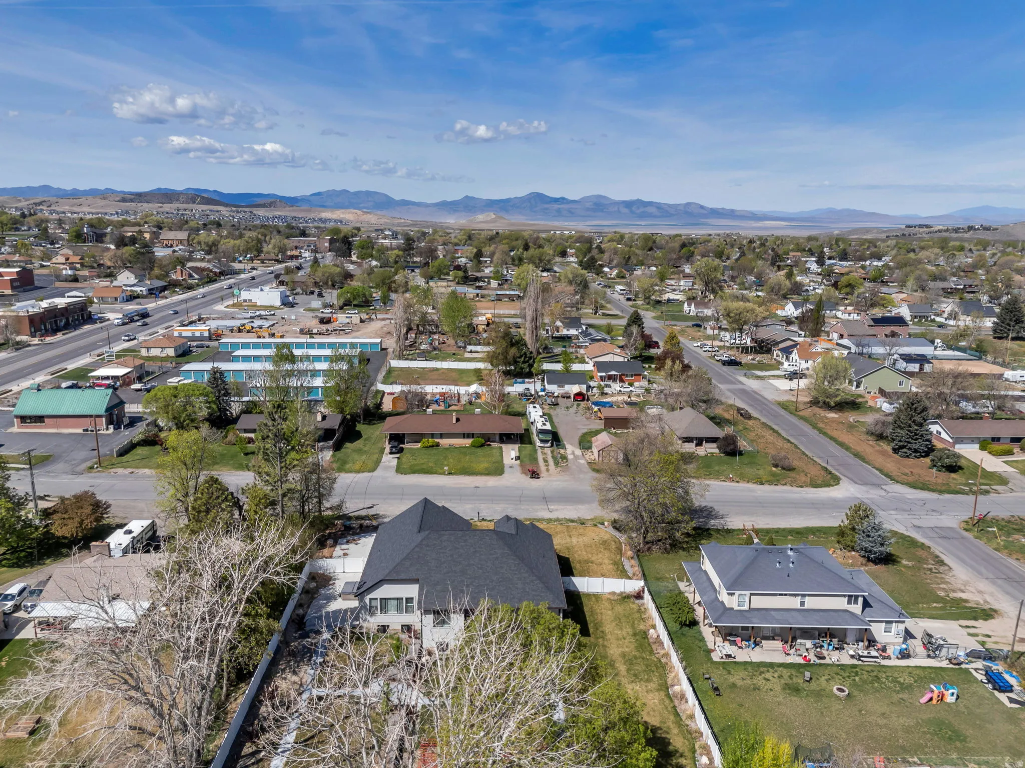 Aerial perspective of suburban area with a mountainous background
