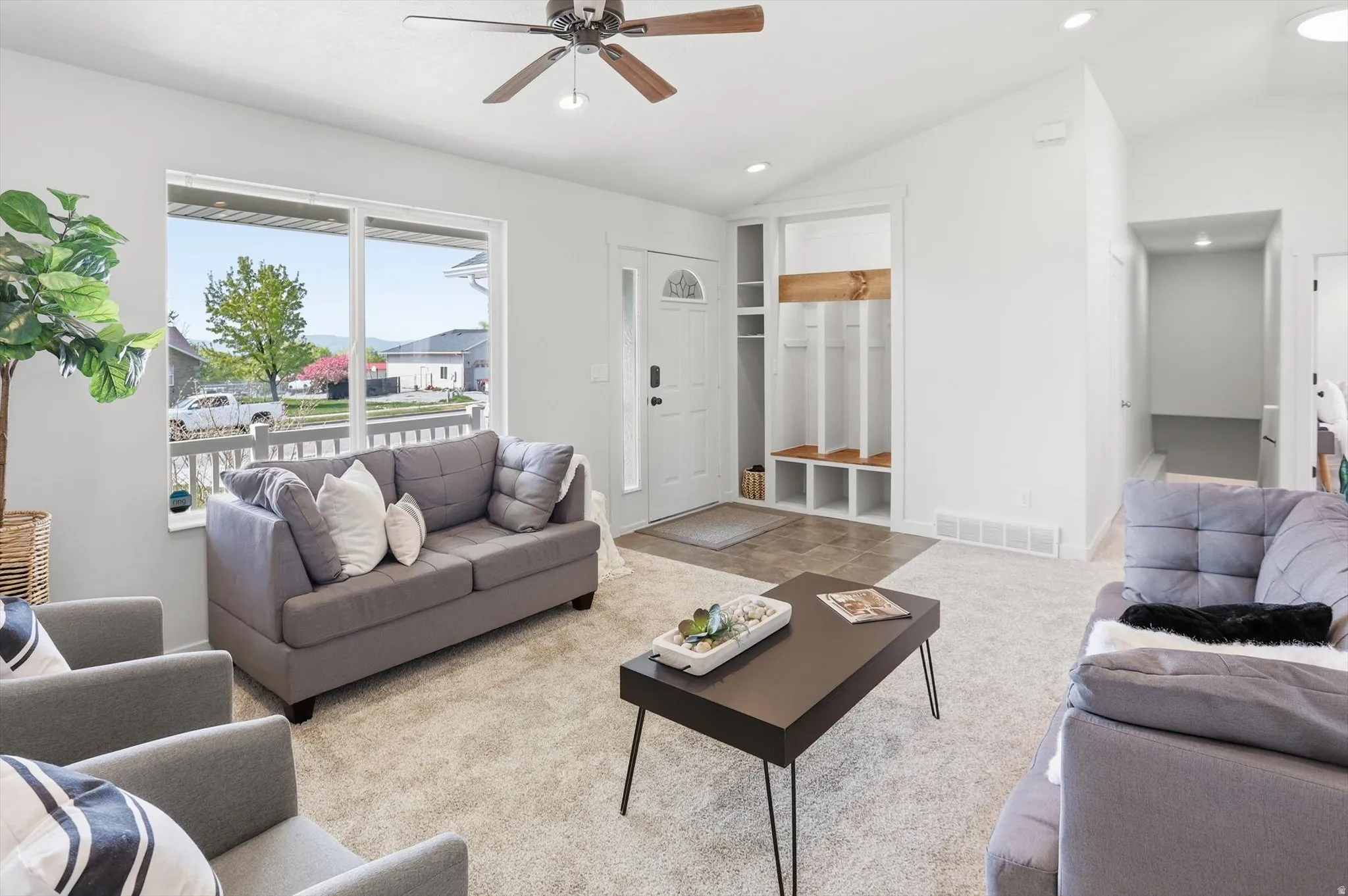 Living area featuring a ceiling fan, vaulted ceiling, and recessed lighting