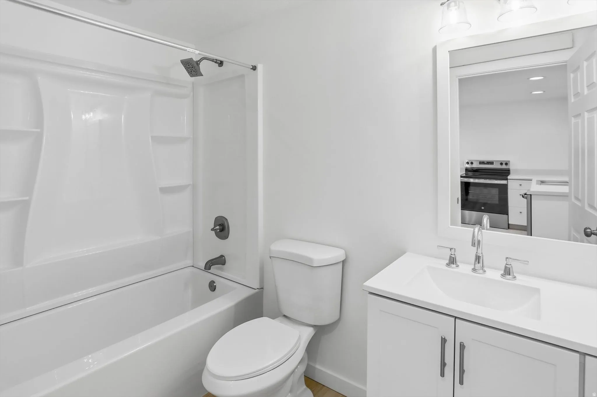 Full basement bathroom with vanity, tub / shower combination, and recessed lighting