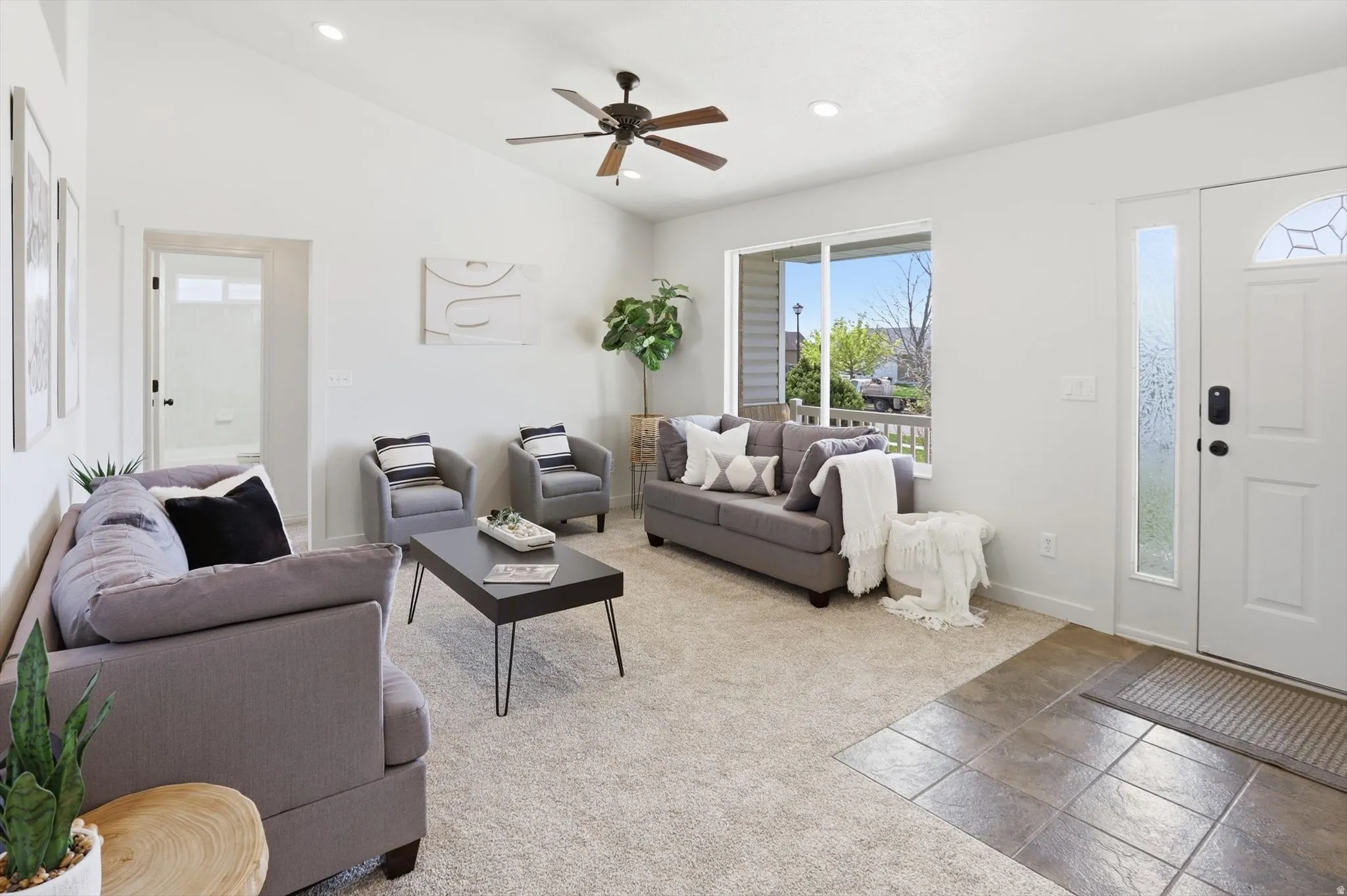 Carpeted living area featuring recessed lighting, ceiling fan, and lofted ceiling