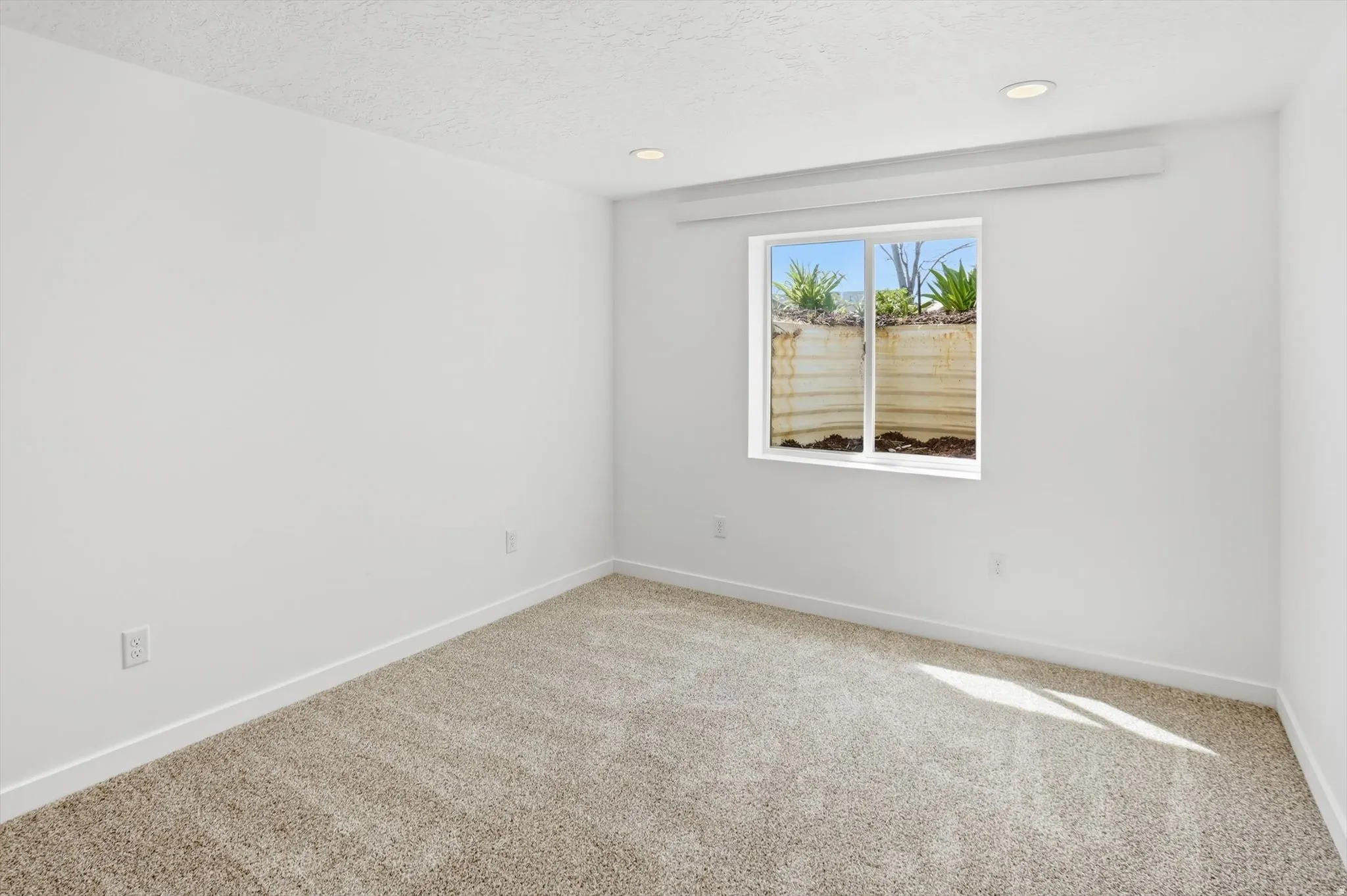 Front basement bedroom with carpet and recessed lighting