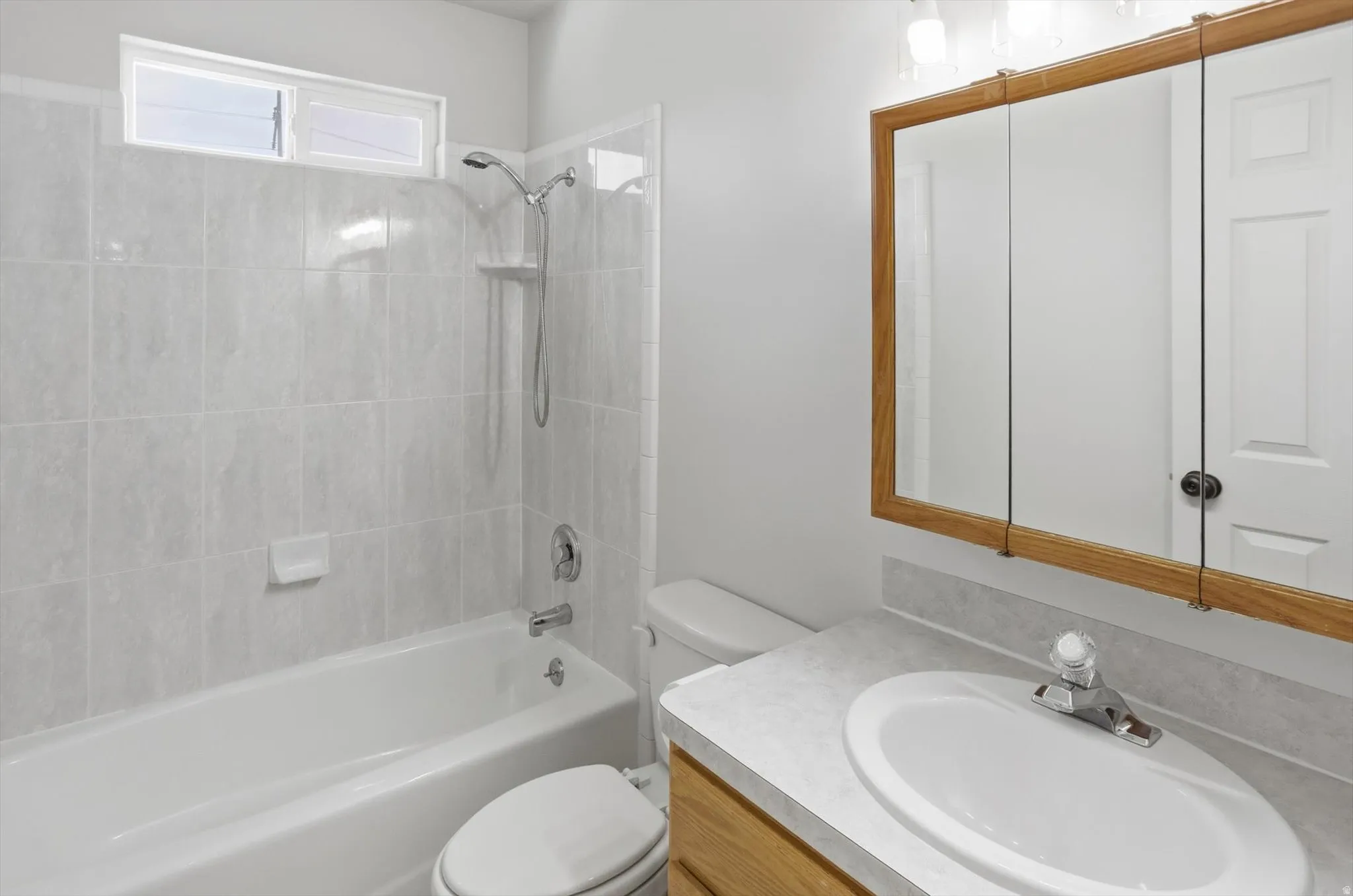 Full bathroom in the hall with vanity and bathing tub / shower combination