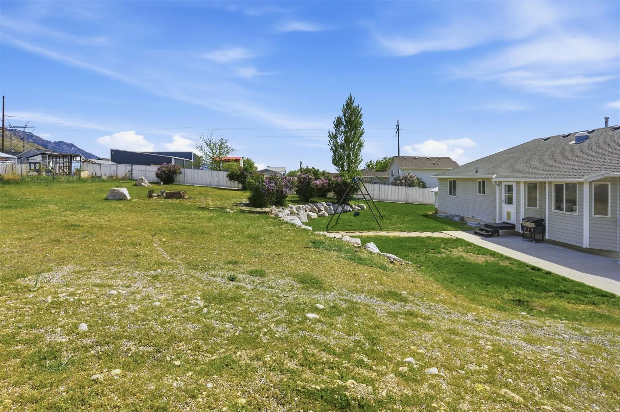 Fenced backyard with a patio area