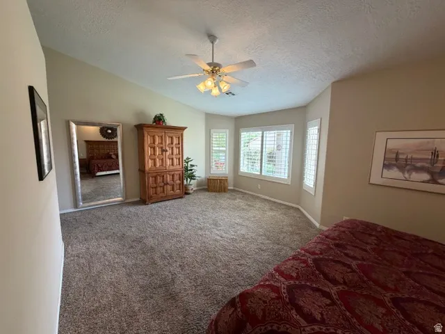 Bedroom featuring carpet and ceiling fan