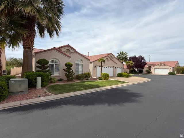 Mediterranean / spanish home with a tiled roof and stucco siding