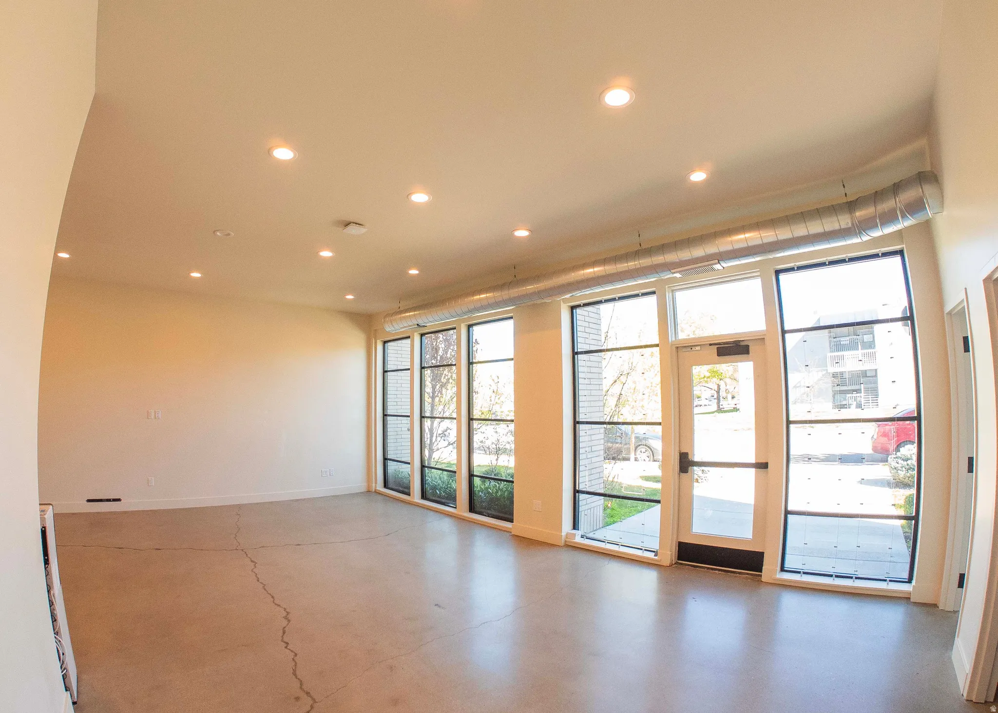 Unfurnished room featuring finished concrete floors and recessed lighting
