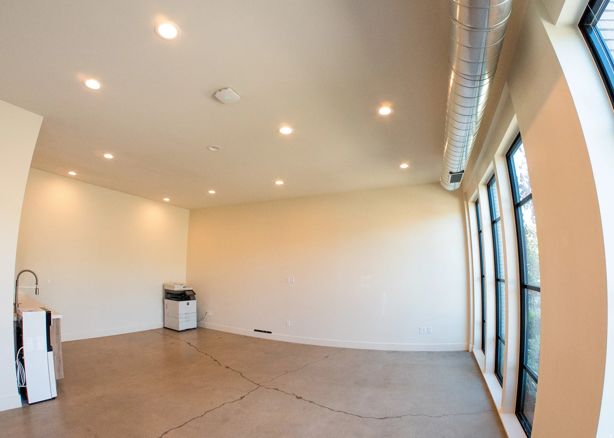 Empty room with recessed lighting and concrete floors