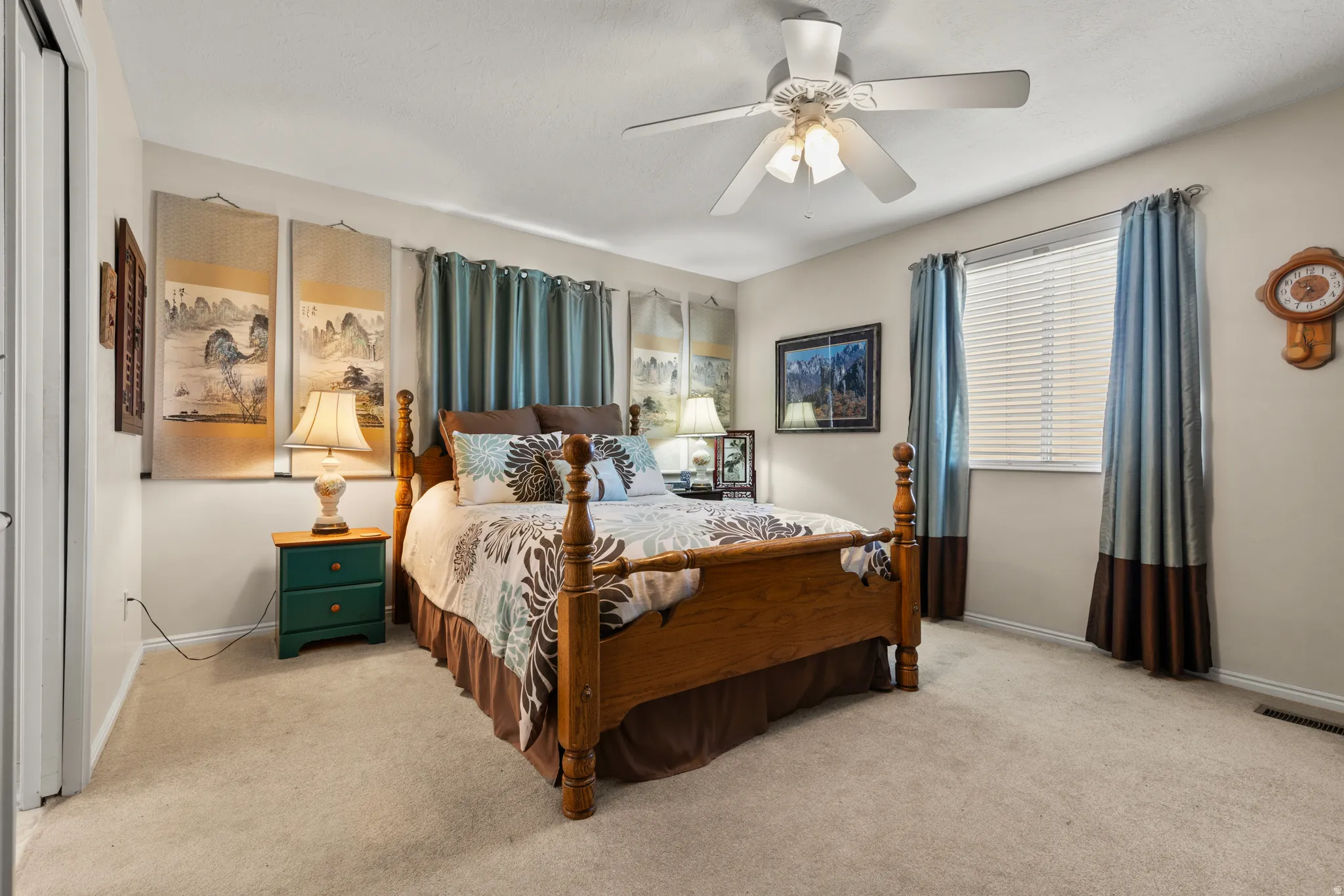 Bedroom with a ceiling fan and light colored carpet