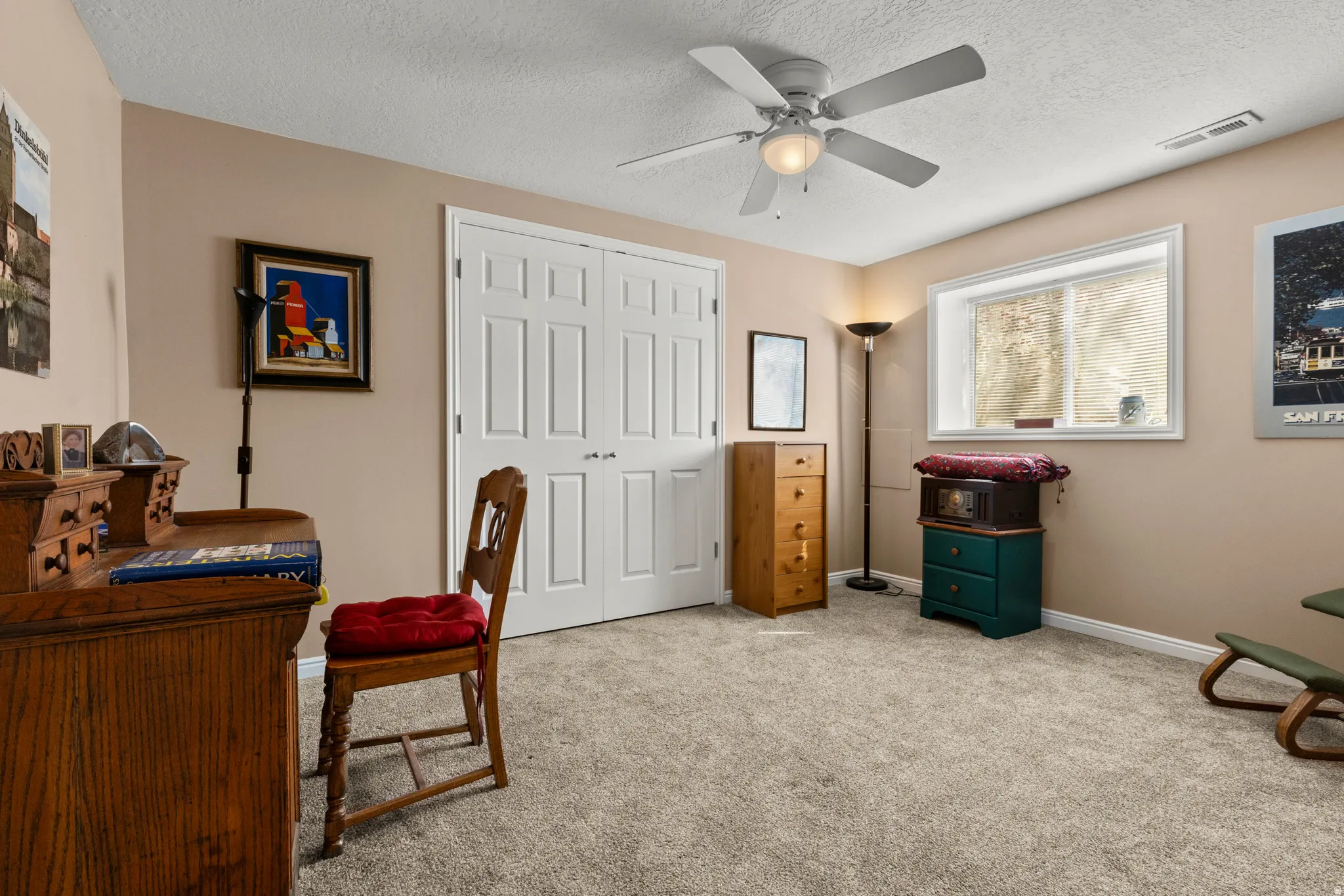 Office featuring light carpet, ceiling fan, and a textured ceiling