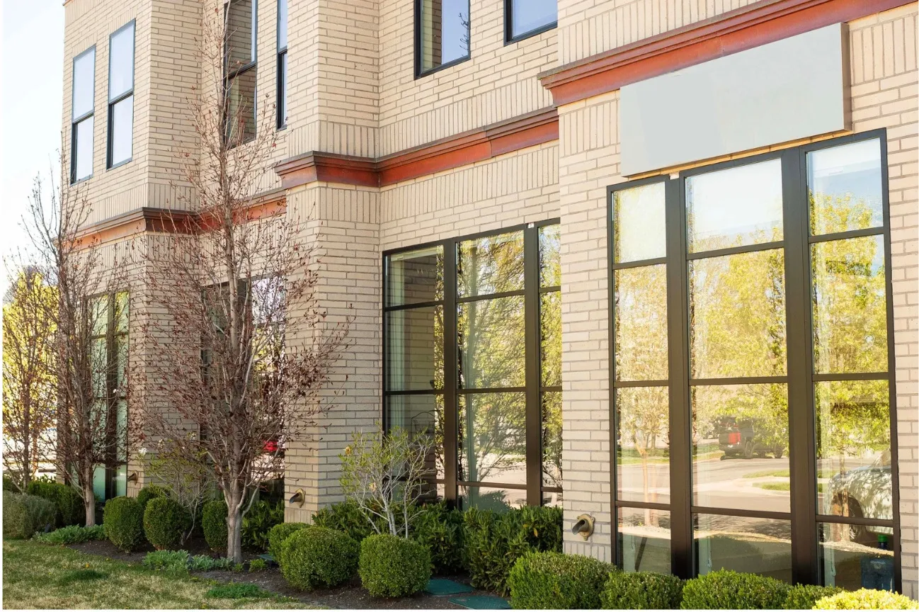 Light-toned brick exterior with dark trim accents