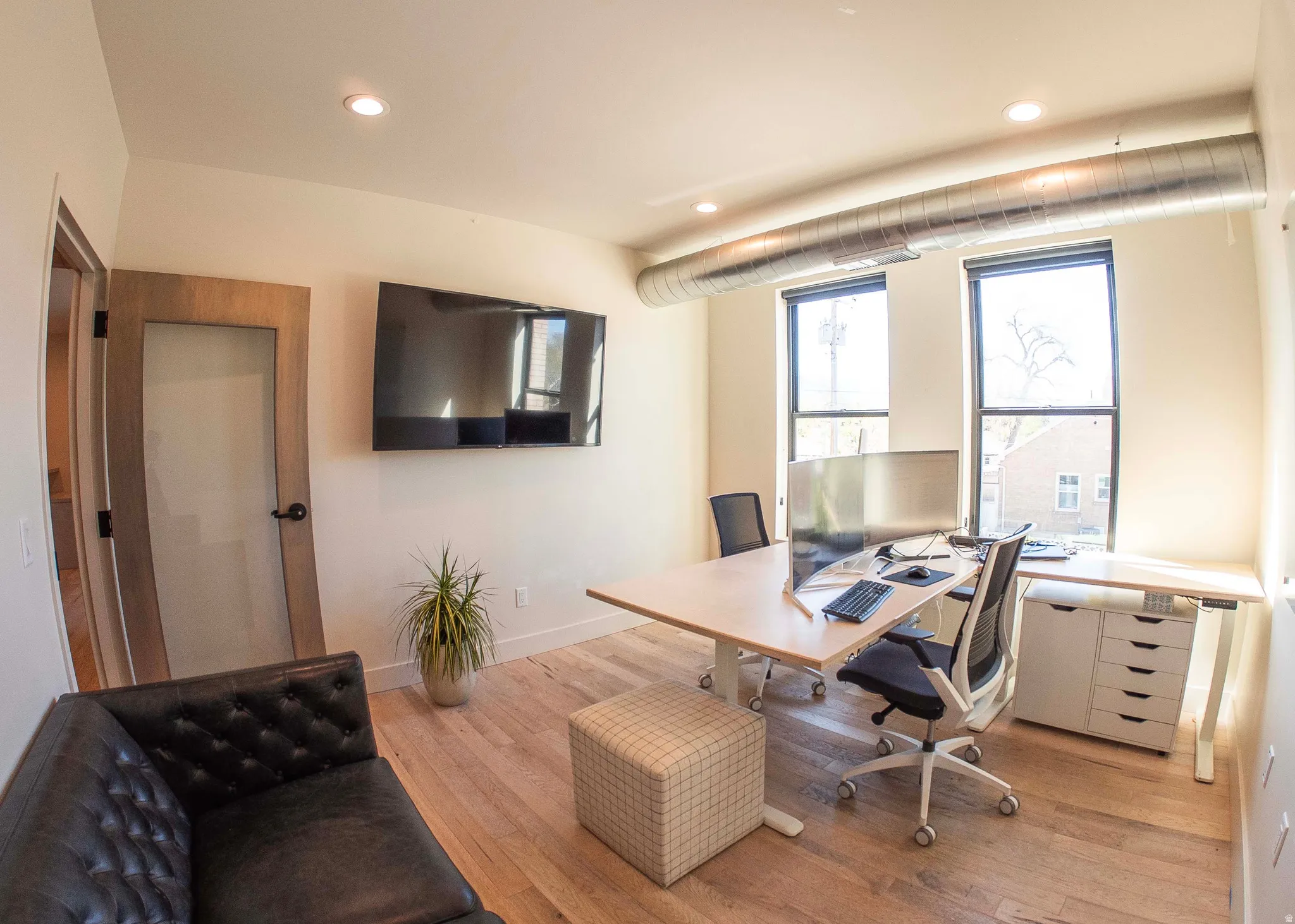 Home office with wood finished floors and recessed lighting