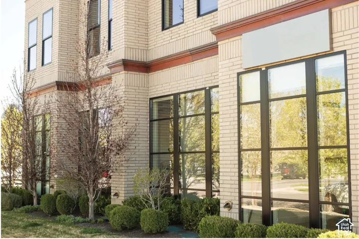 Light-toned brick exterior with dark trim accents