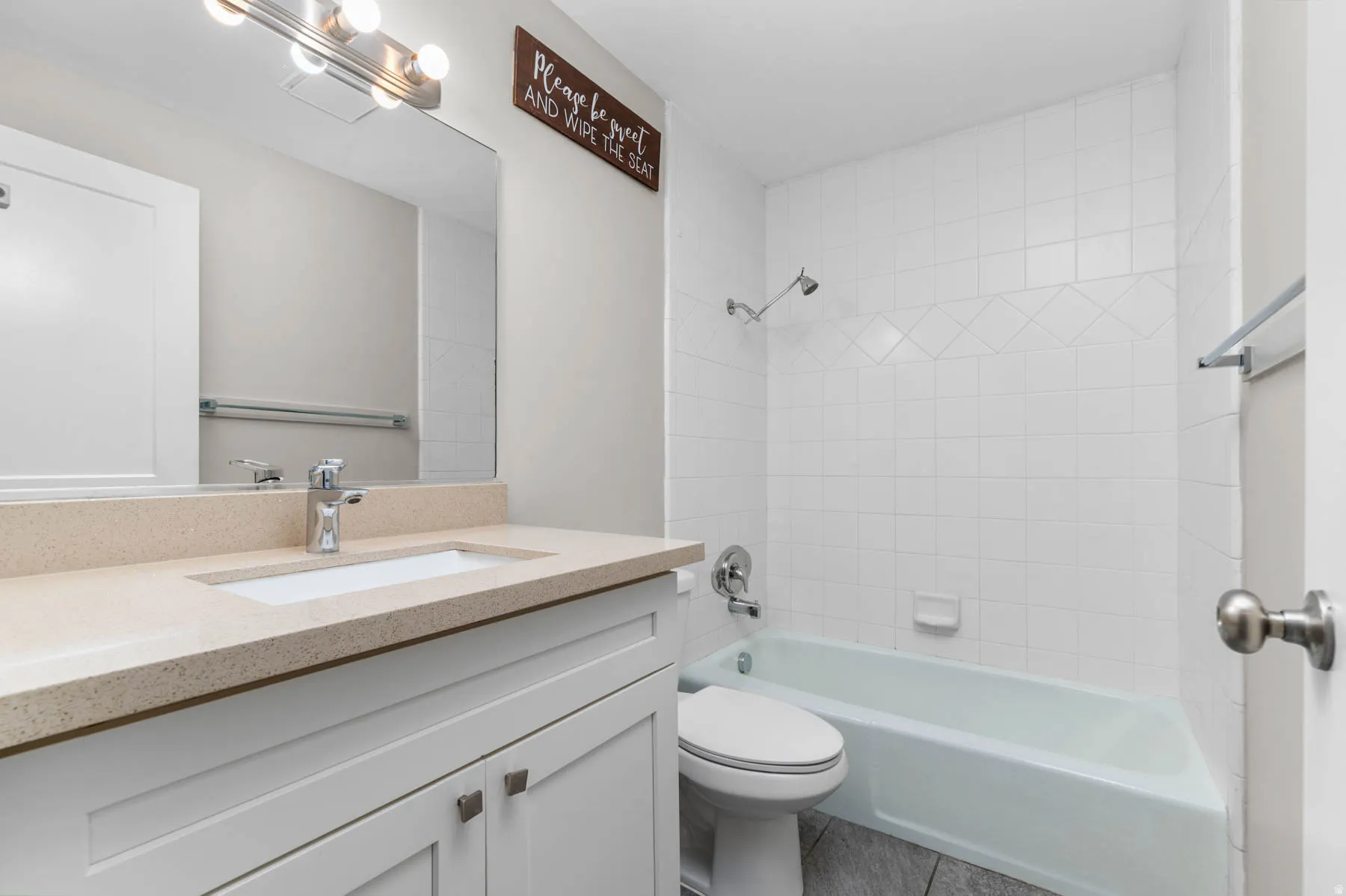Full bath featuring vanity, bathing tub / shower combination, and tile patterned flooring