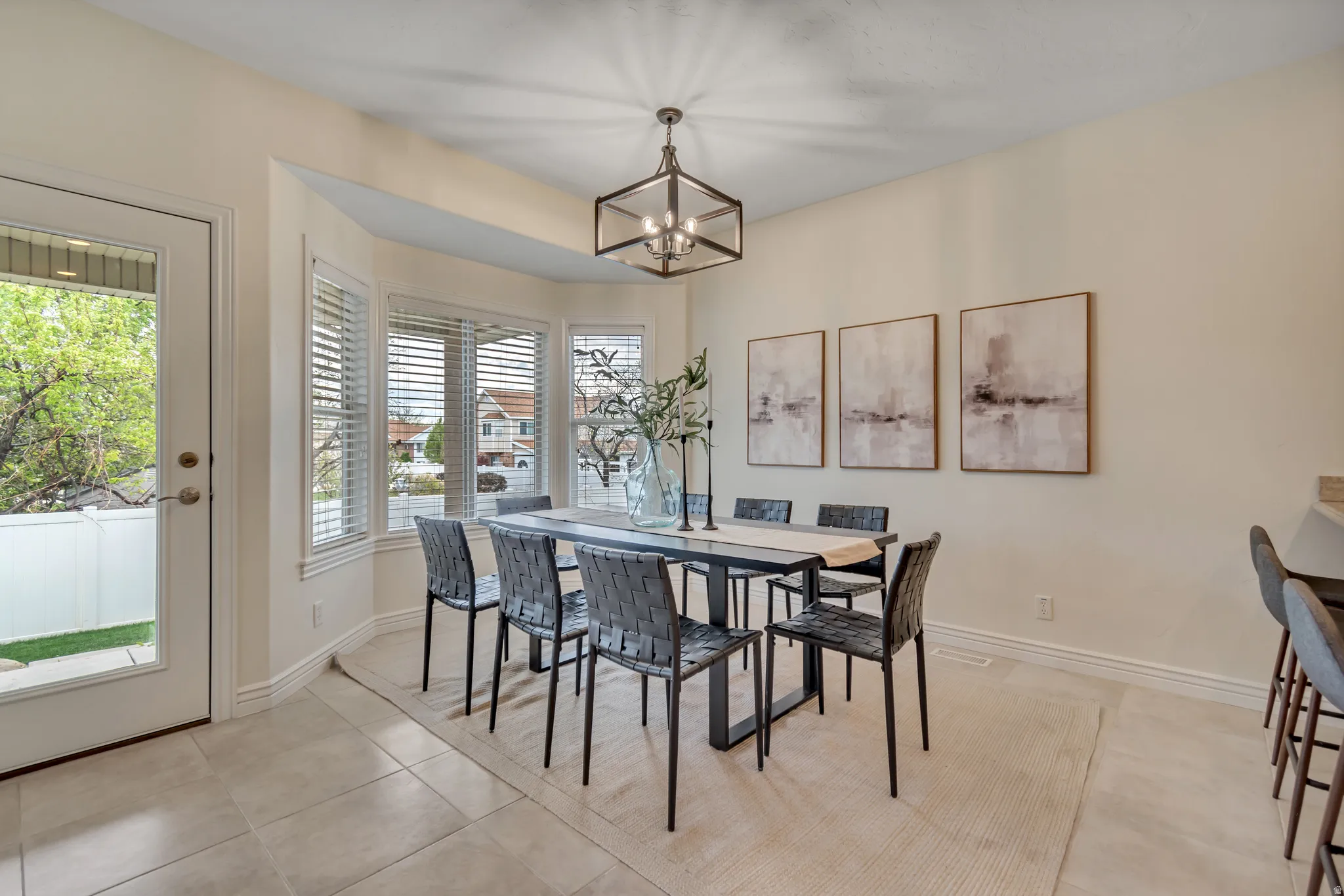 Dining room with a chandelier and light tile patterned flooring