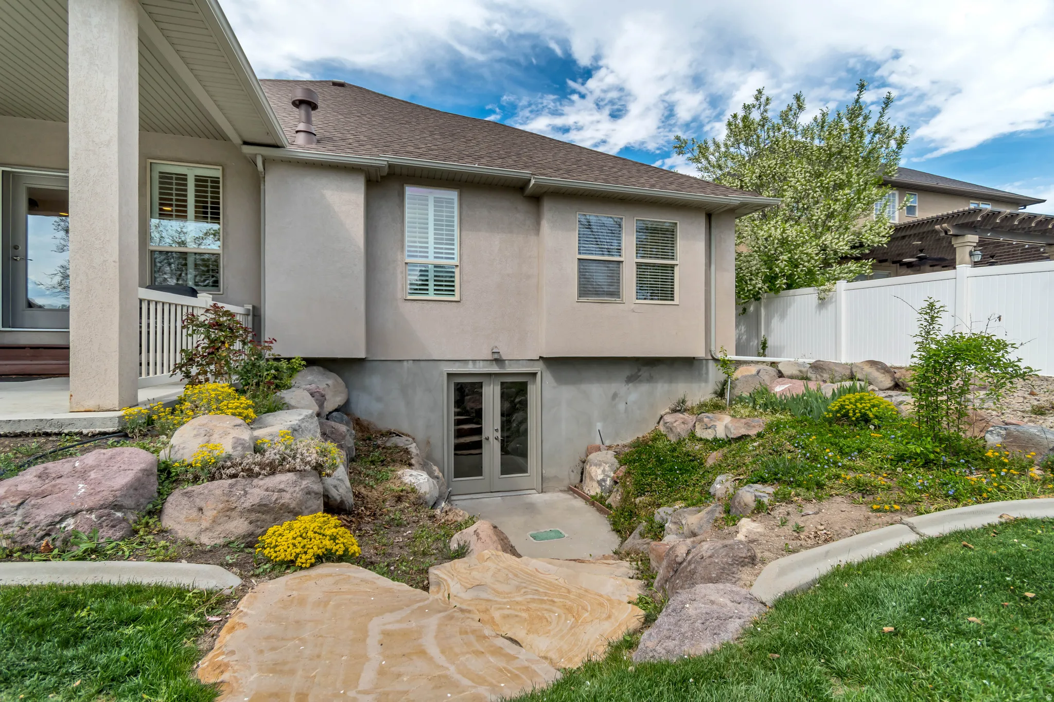 Back of house with french doors, stucco siding, and a shingled roof