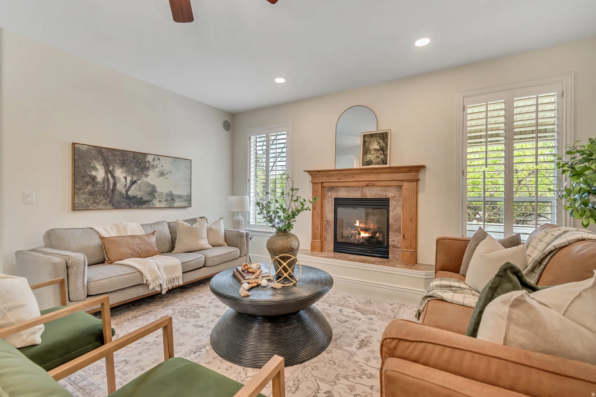 Living room featuring a ceiling fan, a premium fireplace, and recessed lighting