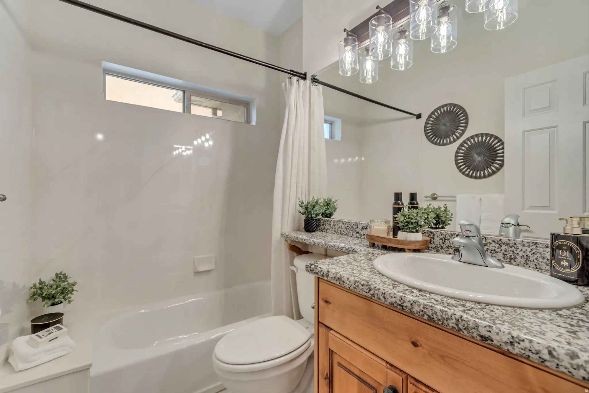 Full bath featuring vanity and shower / tub combo
