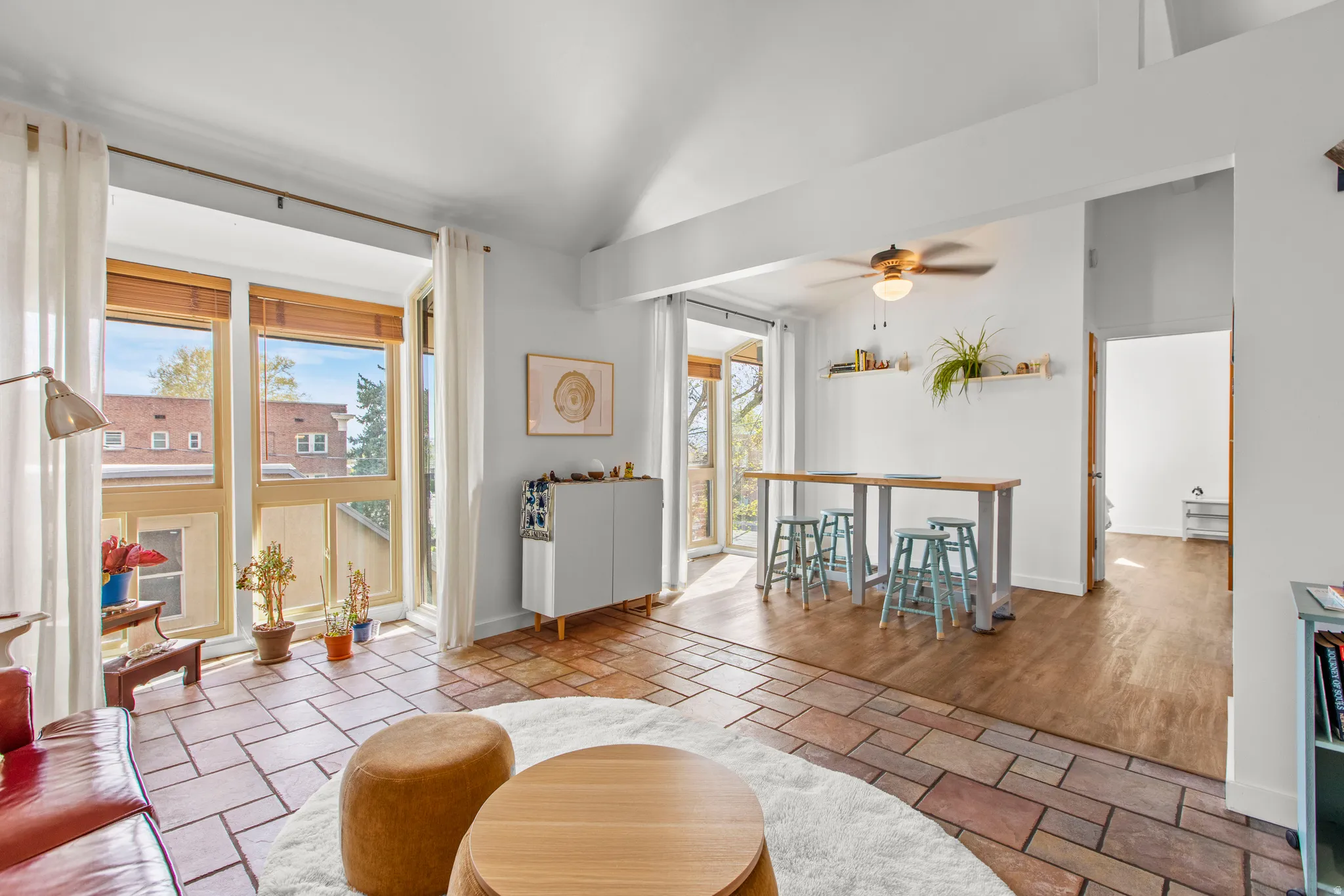 Living area featuring large windows and vaulted ceilings