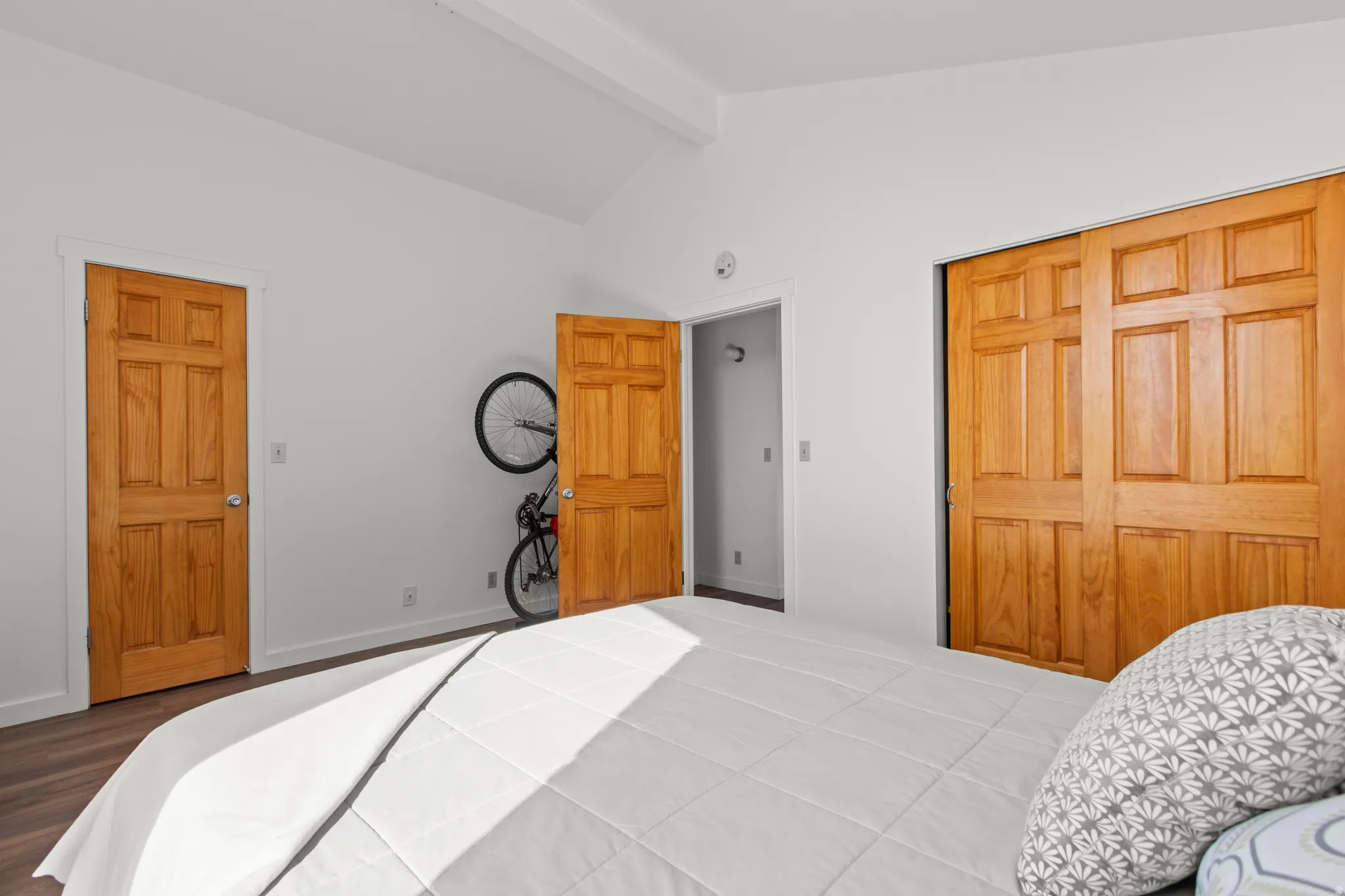 Bedroom with lofted ceiling, large windows, and LVP floors