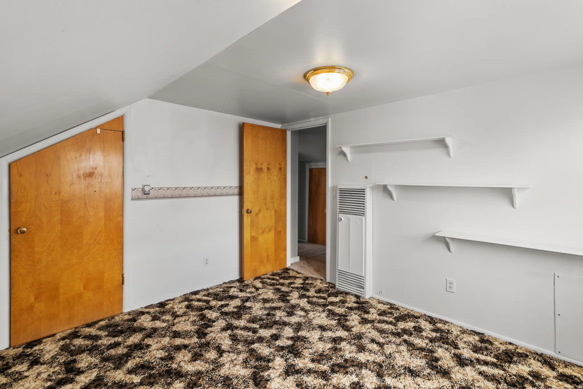 Unfurnished bedroom featuring carpet flooring and a heating unit