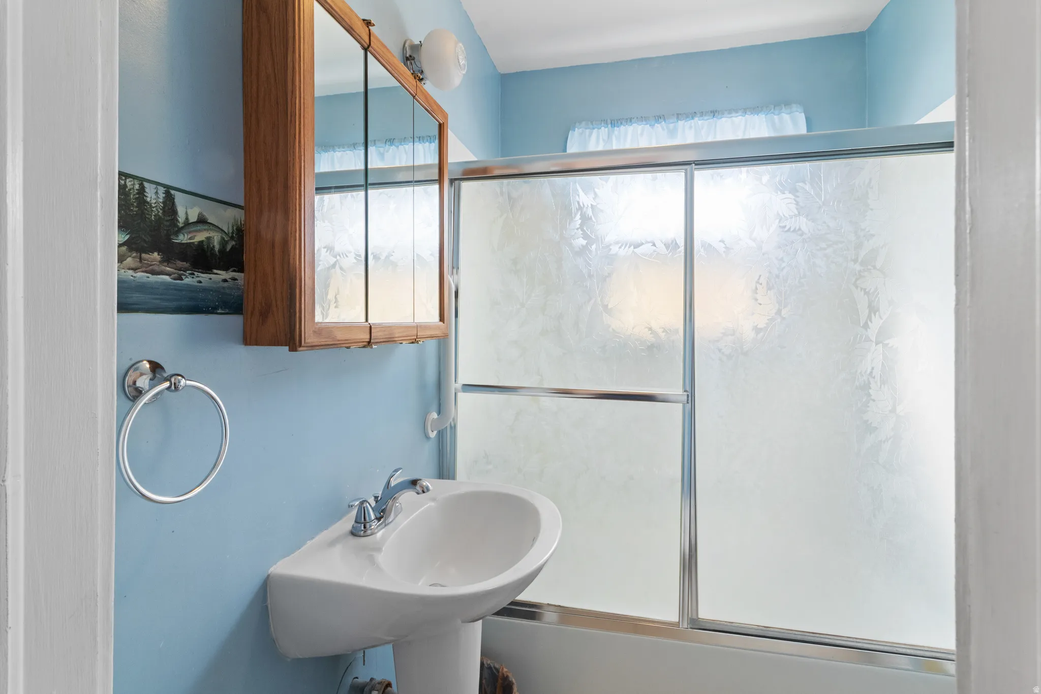 Full bathroom featuring combined bath / shower with glass door