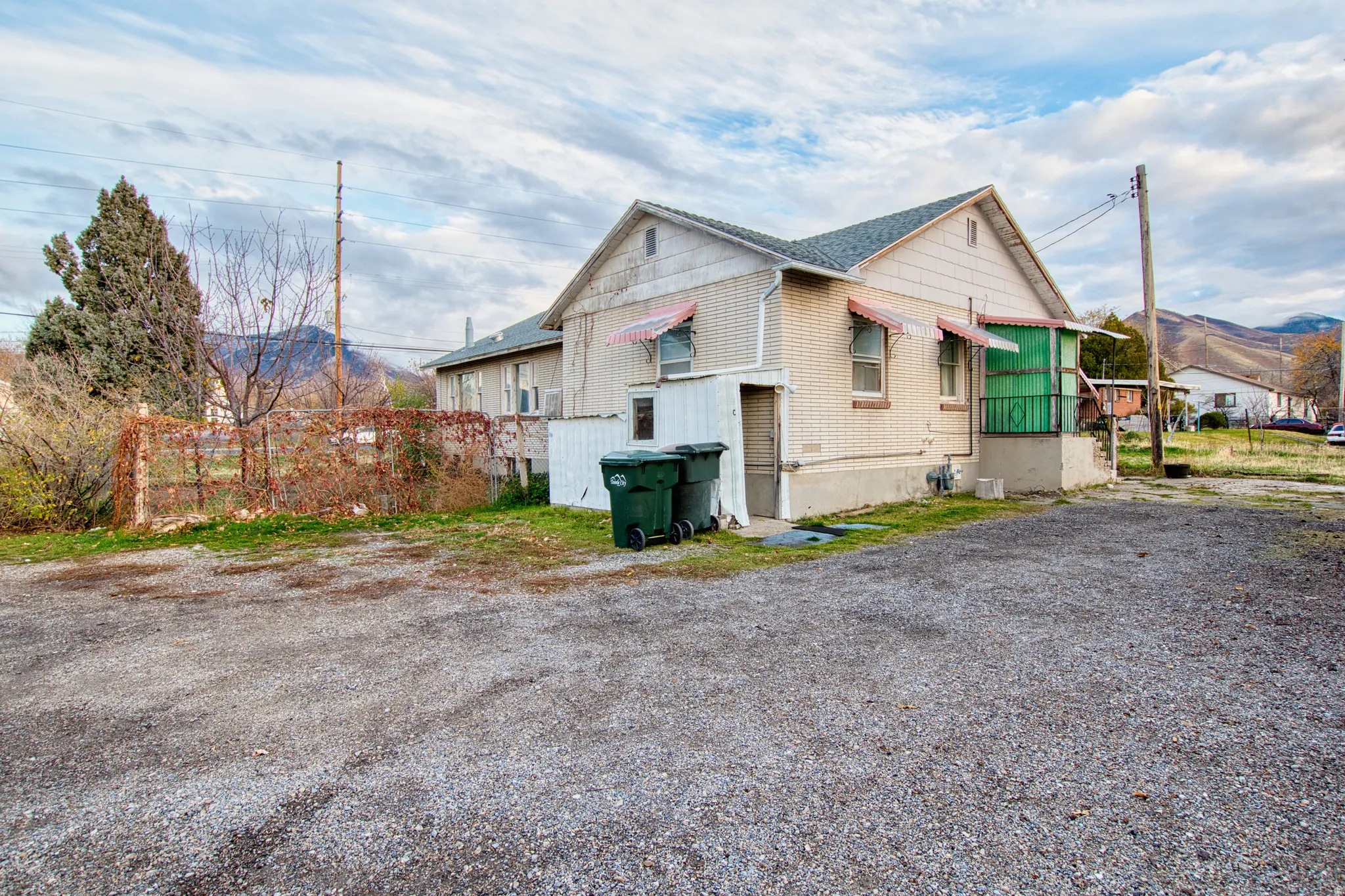 View of side of home with a mountain view and brick siding