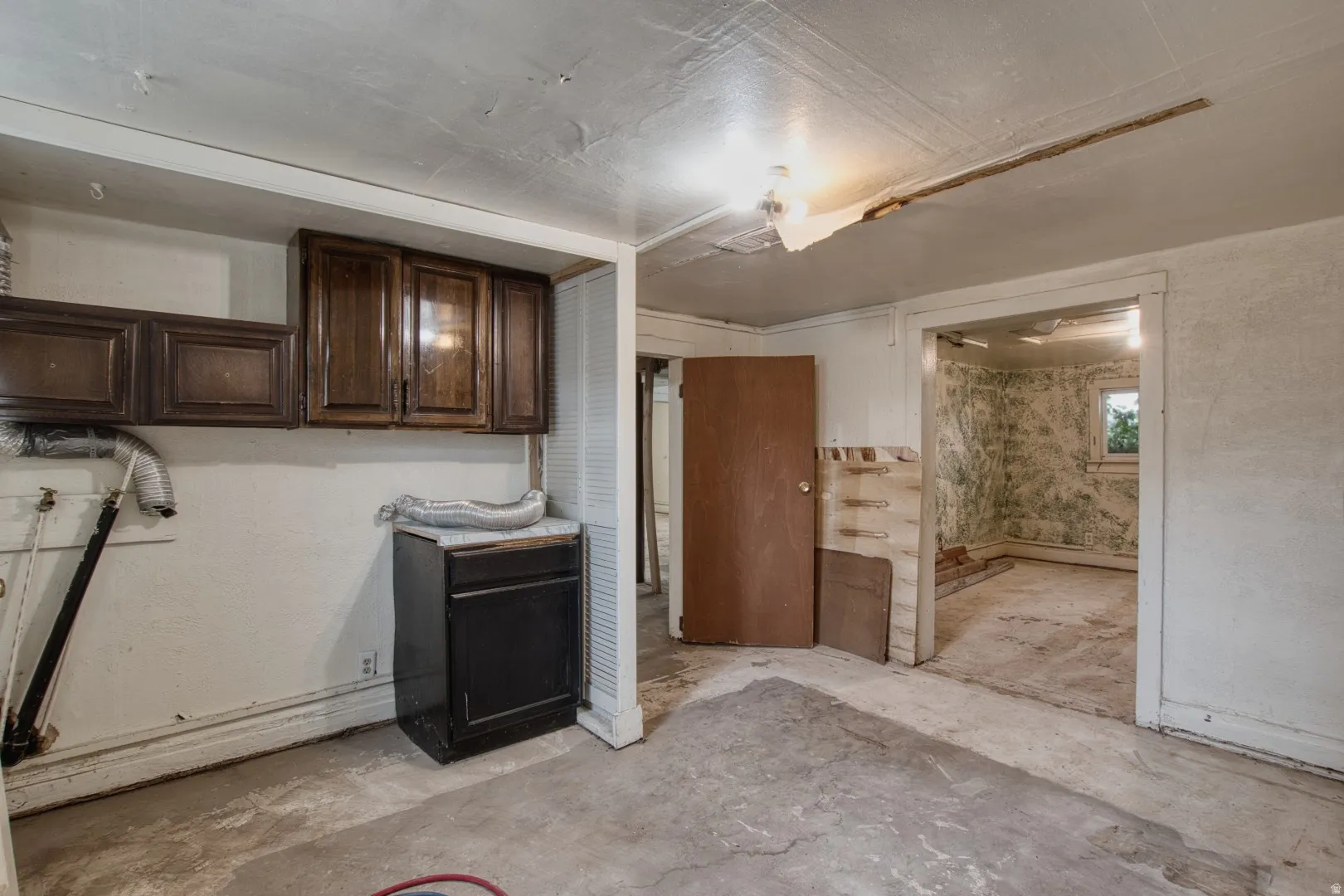 Laundry room featuring unfinished concrete floors