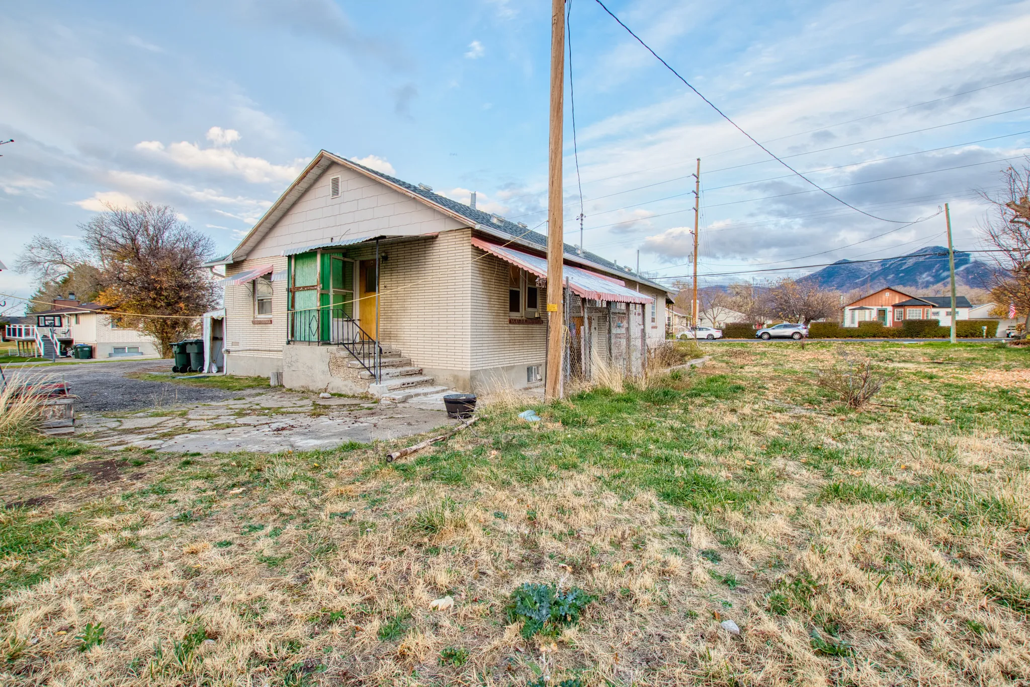 Rear view of house featuring brick siding, a mountain view, and a patio