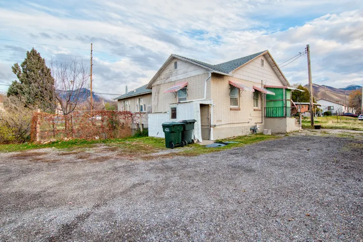 View of side of home with a mountain view and brick siding