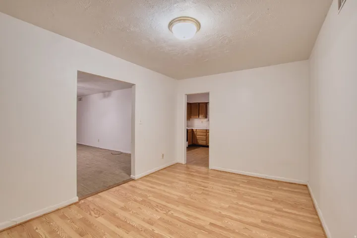 Dining room featuring light wood-style floors and a textured ceiling