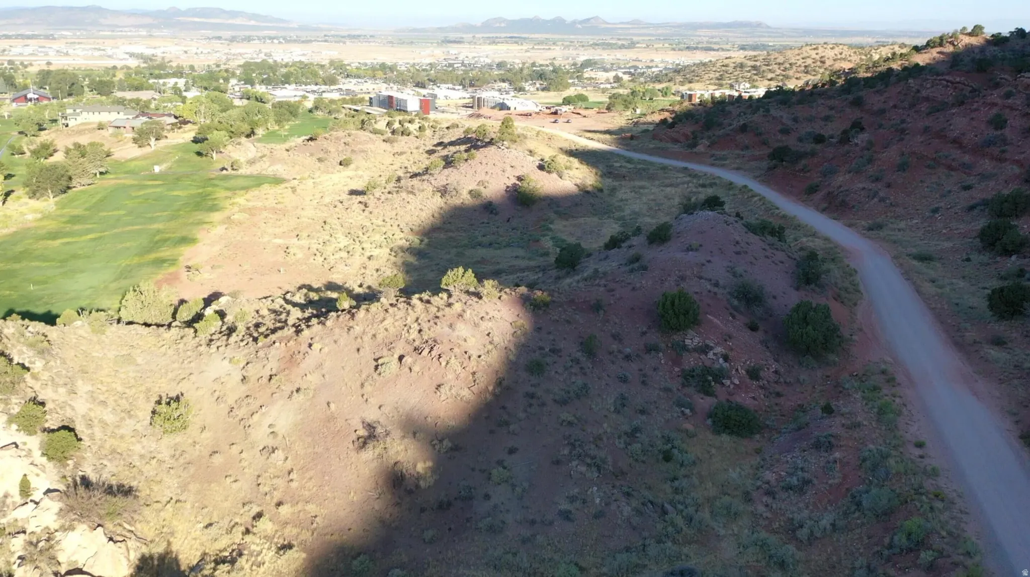 View of property location featuring mountains and a golf course
