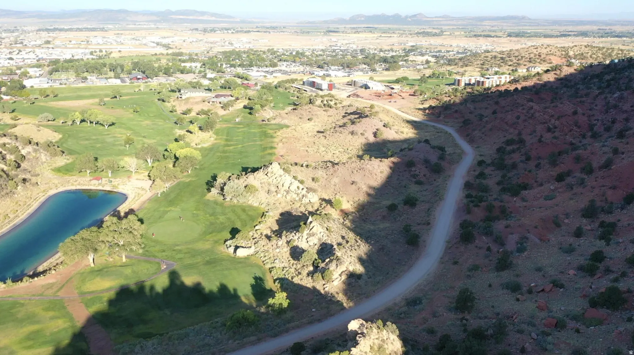View of property location with a water and mountain view and a local golf course